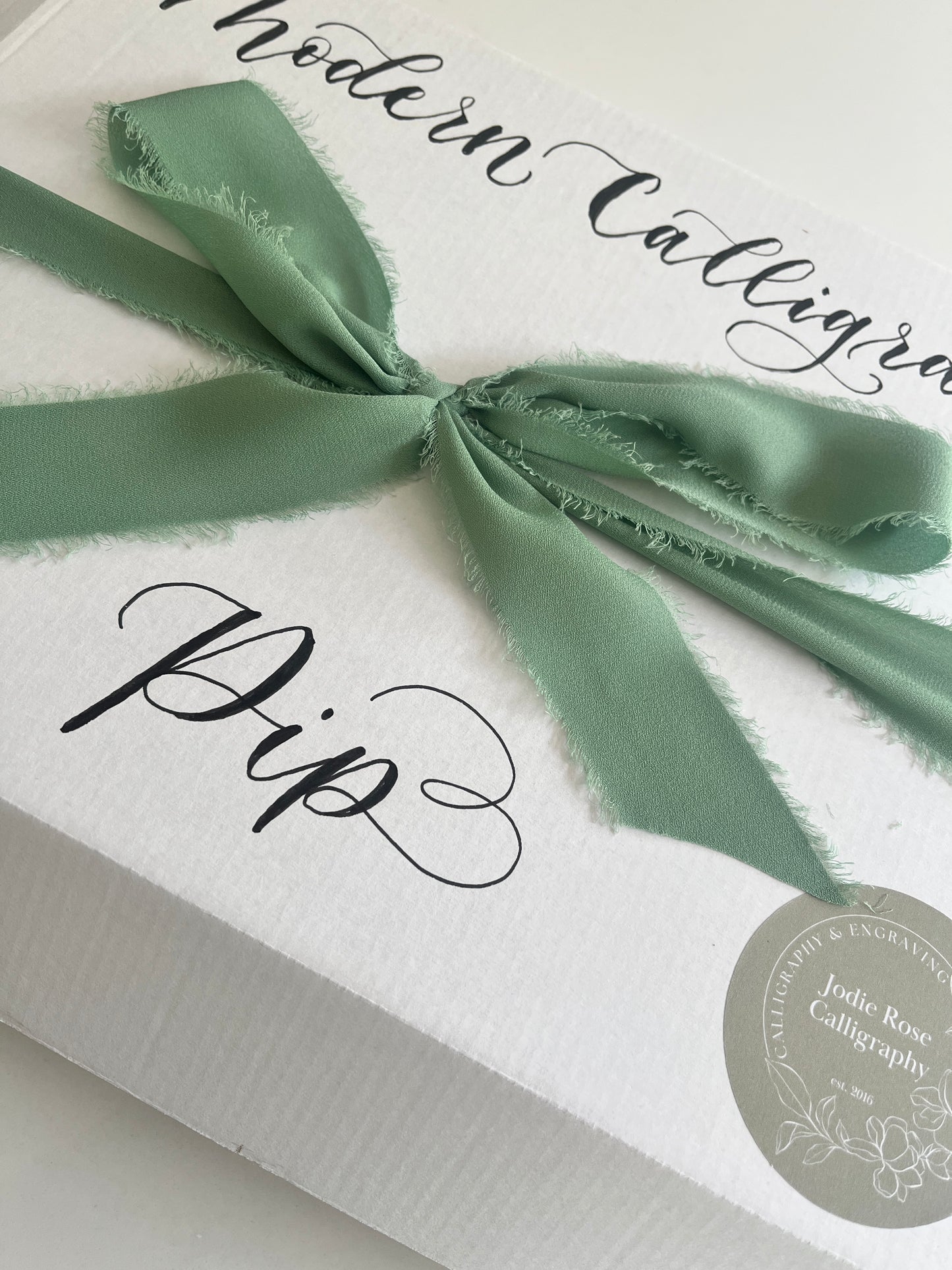 Modern calligraphy kit with pens, ink, and practice sheets for beginners