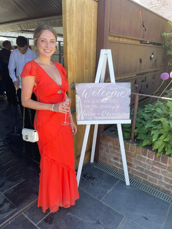Jodie Rose Calligraphy with acrylic welcome signage at Southend Barns wedding venue in West Sussex